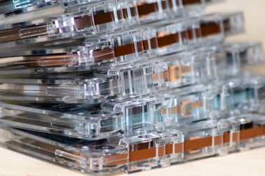 Batch of old outdated retro magnetic tape cassettes as beautiful contrast to modern technologies bringing memories of childhood back to life
