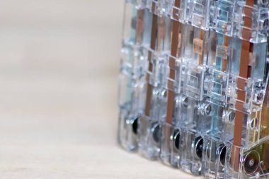 Batch of old outdated retro magnetic tape cassettes as beautiful contrast to modern technologies bringing memories of childhood back to life