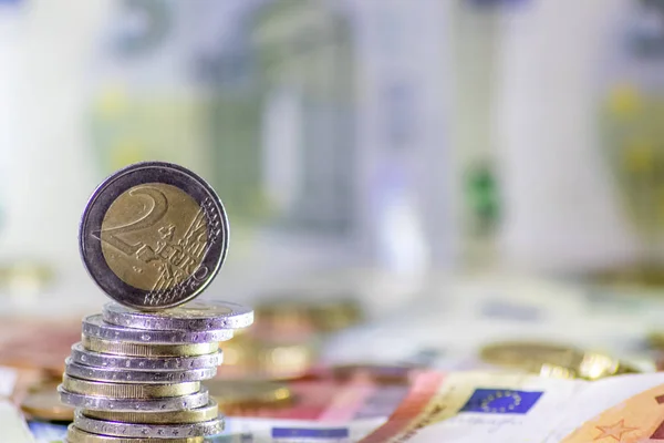 Stack of european coins and bank notes in the background show international finance with euro and europe, european trade and financial trade as well as saving, financial success and credit management