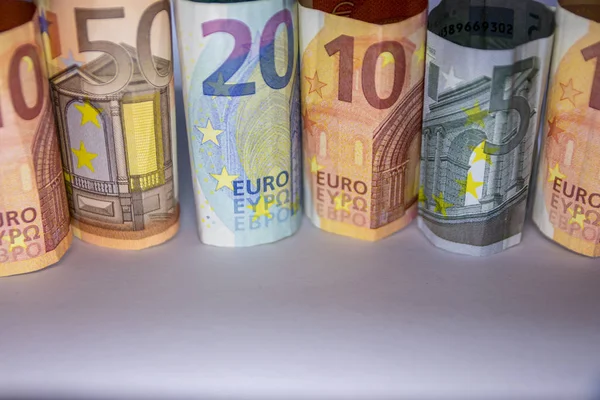 Different european bank notes rolled to bank note tubes show a 50 euro bank note, a 20 euro bank note, 10 euro and 5 euro and symbolize european financial market and international trade with europe