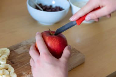 Avrupalı çocuk elleri, kahvaltıda kırmızı elma ve muz gibi keskin bir bıçakla meyve kesiyor ya da mutfak masasında vitaminlerle beslenen bir diyet yemeği gibi vitaminli atıştırıyor.