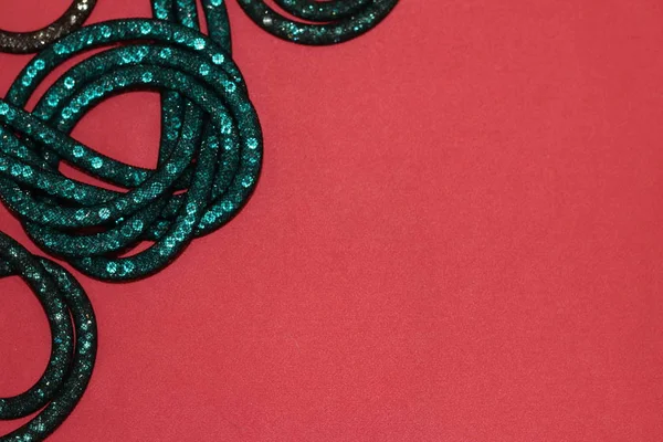 turquoise crystals in a grid on a pink background