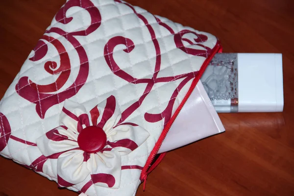 red handmade cosmetic bag with cosmetics