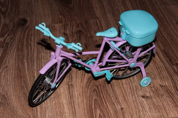 Pink toy bike. Pink and blue transport for dolls.