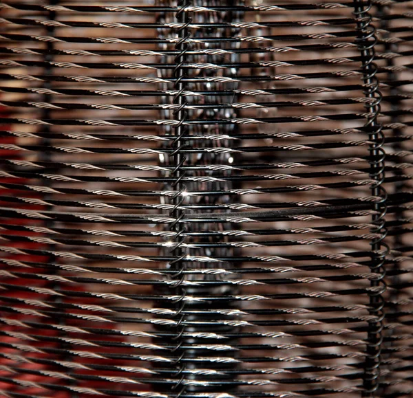 Texture of an iron mesh with a diamond cut.