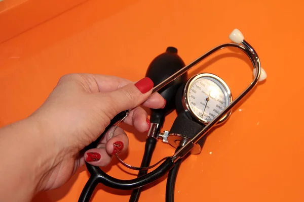 Tonometer in a woman\'s hand with a manicure. A device for measuring pressure.