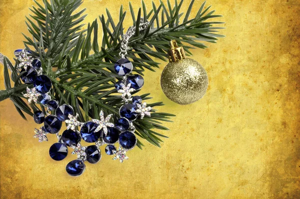 抽象的な背景のボールでクリスマス ツリーの枝に青い石のネックレス — ストック写真