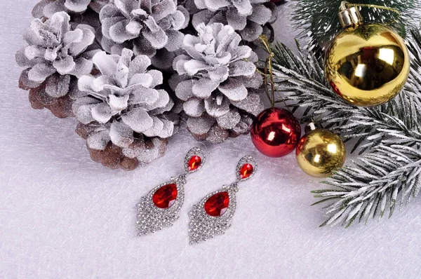 Silver earrings with red crystals christmas background. — Stock Photo, Image