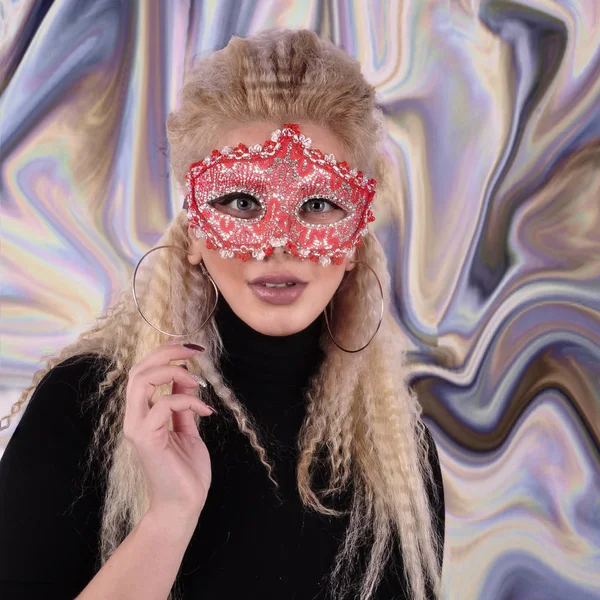 Girl in a red carnival mask on an abstract background. — Stock Photo, Image