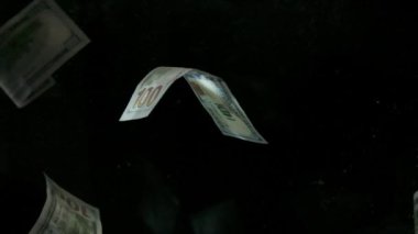 4K Loopable 'daki siyah arka planda düşen Amerikan doları banknotları. 4K 'da yüksek kalitede düşen dolar banknotları. Görüntü Döngüsel