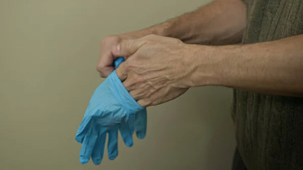 Man Wearing Blue Rubber Protective Medical Gloves Indoor Protect Himself — Stock Photo, Image