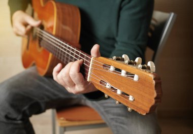 green jersey playing the guitar