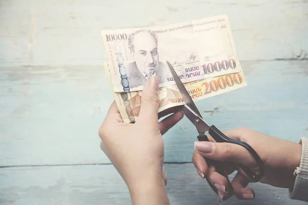 Woman hand scissors and money — Stock Photo, Image