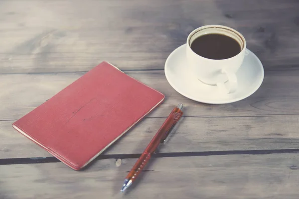 Red notebook with pen and coffee — Stock Photo, Image