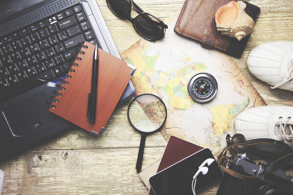 Notebook and traveling Items on the wooden table