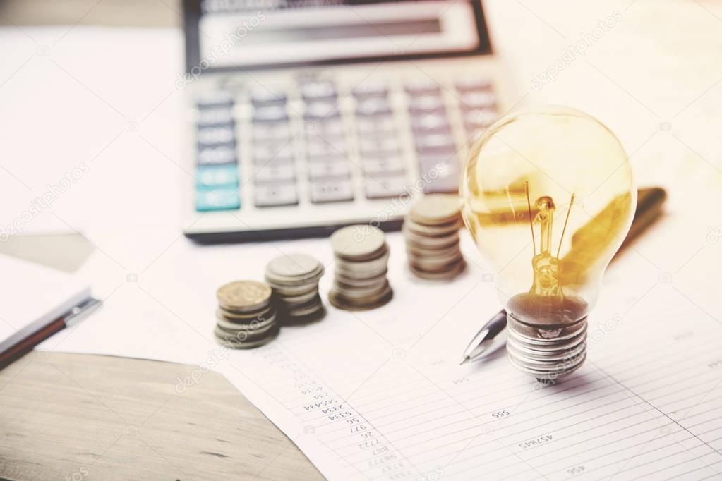 bulb,money, calculator and pen