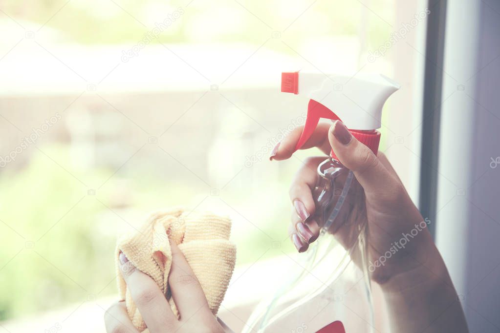 Woman is cleaning windows.