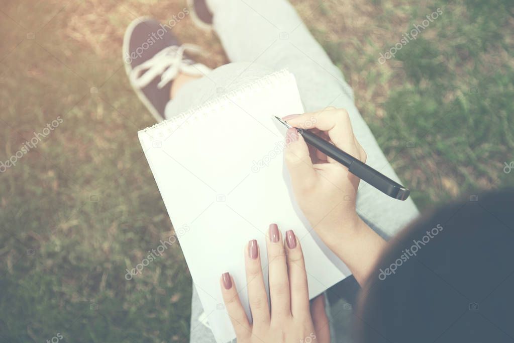 woman hand notebook on nature