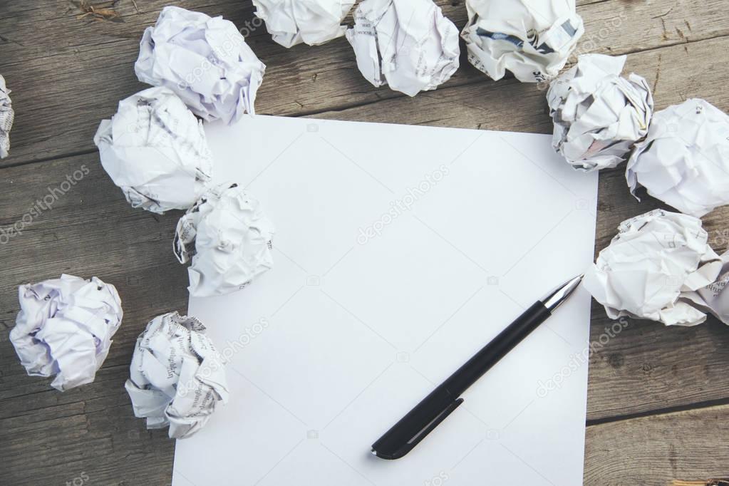 paper surrounded with crumpled papers 