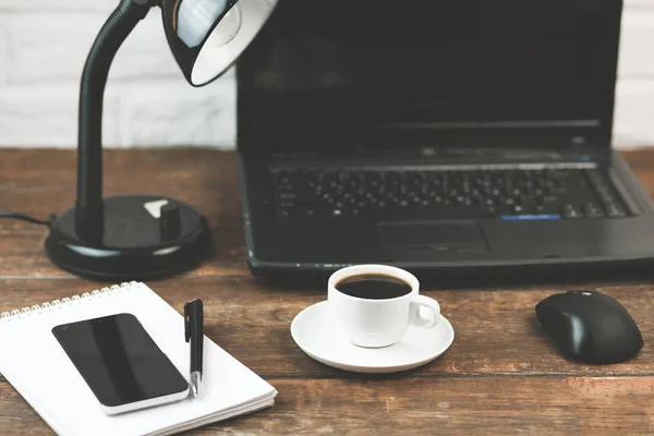 computer, coffee, notebook and lamp