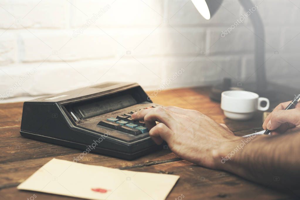 Business man using a calculator 
