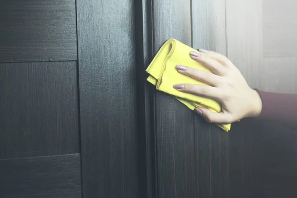 hand cleaning a door