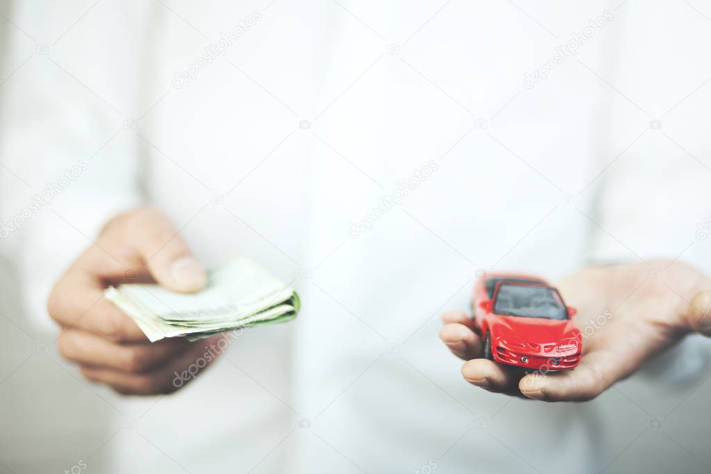 Man with car and money in hands