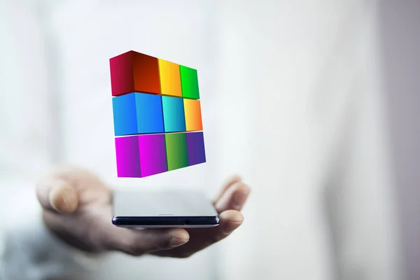 Businessman holding phone with  digital cube above