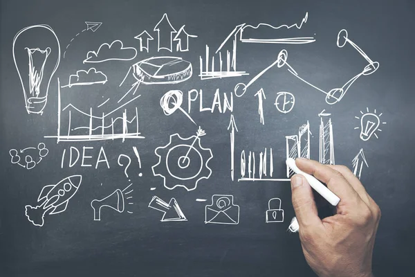 Man written business doodles on  blackboard — Stock Photo, Image