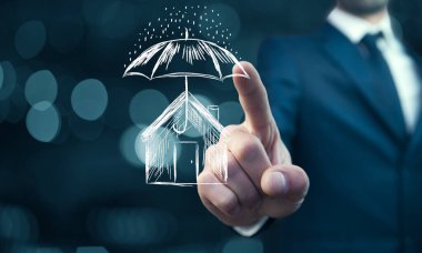 Businessman drawing umbrella over house