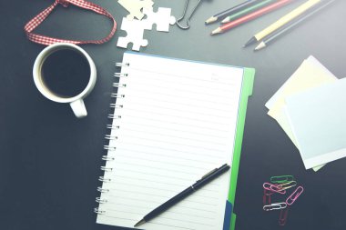 Office table with a coffee cup a blank notepad