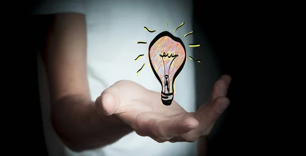 Businessman holding hand drawn lightbulb in his hand — Stock Photo, Image