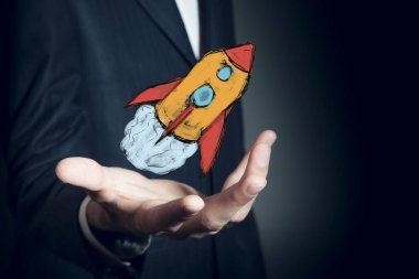 İşadamı eli kırmızı roket 