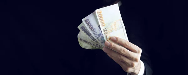 Young businessman hand money — стоковое фото