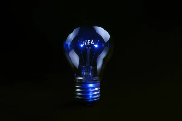 Idea text on light bulb — Stock Photo, Image
