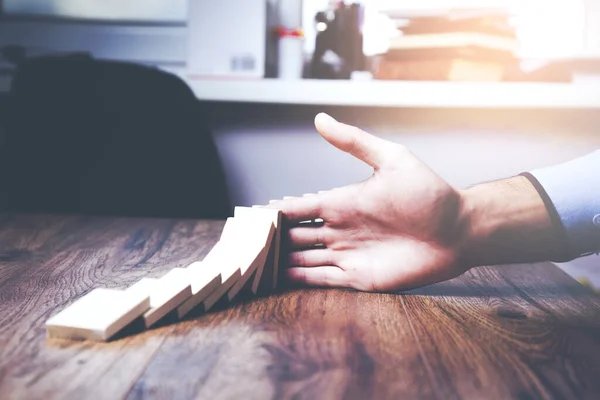 Businessman Stopping Wooden Dominoes Bricks Crumbling His Hand — Stock Photo, Image