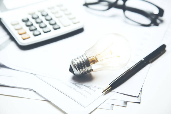 idea or light bulb and calculator on document