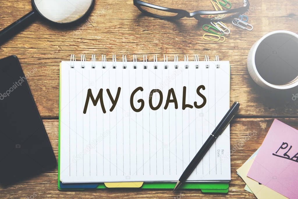 my goals text on page with stationary on table