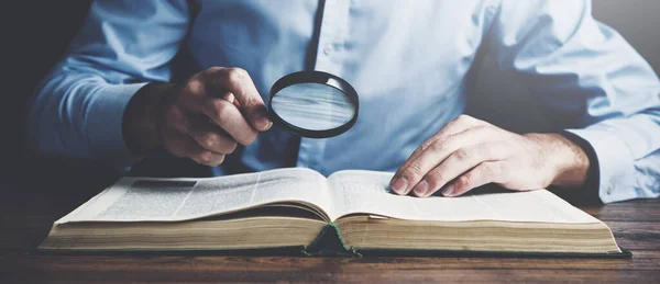 Man Hand Förstoringsglas Läsa Bok Trä Bord Bakgrund — Stockfoto