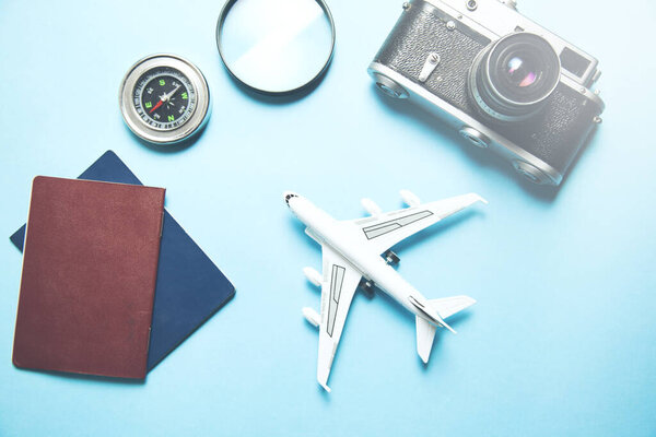 Travel objects on the blue table background