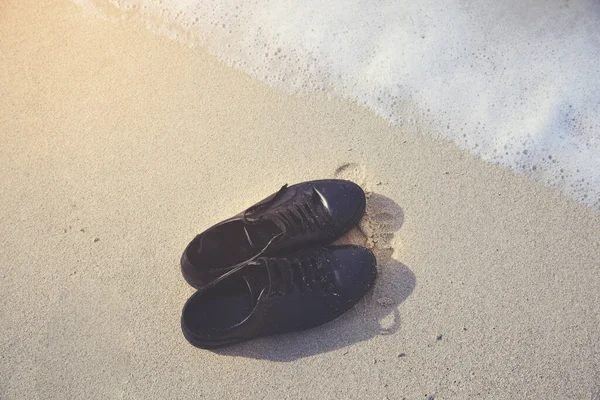 man shoes  on sand on beach