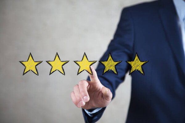 man touching yellow stars in screen