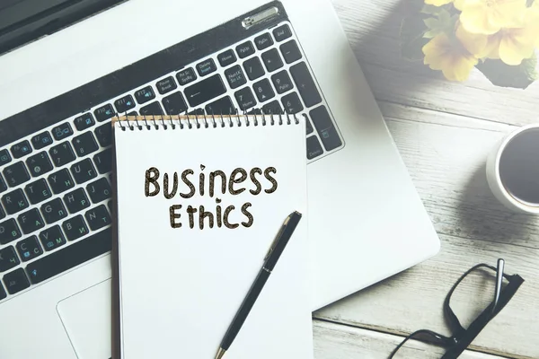 business ethics text on notepad on keyboard