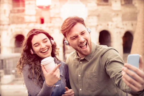 Capture happy moments. Joyful young loving couple making selfie on camera. Happy Friends looking new video on Rome . New technology trends and friendship concept - Image.