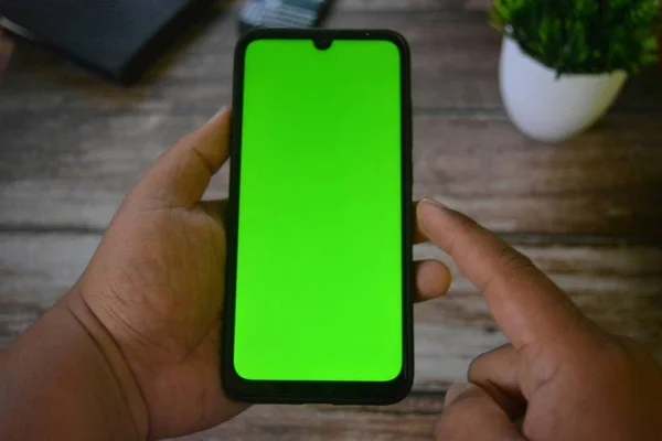 Self Perspective smartphone In the hands of a man with green screen for key chroma screen.