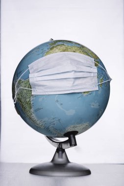 Earth globe with surgical mask Conceptual of health emergency, Covid-19 or coronavirus, pandemic