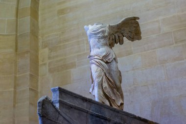 Stone sculpture of a woman without head called Winged Victory of Samothrace clipart