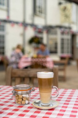 Coffee Latte on Garden Table of English pub in Midlands, UK