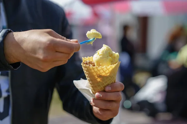 Man holding ice cream cone. Detail of ice cream in hand