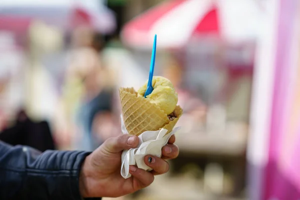 Man holding ice cream cone. Detail of ice cream in hand